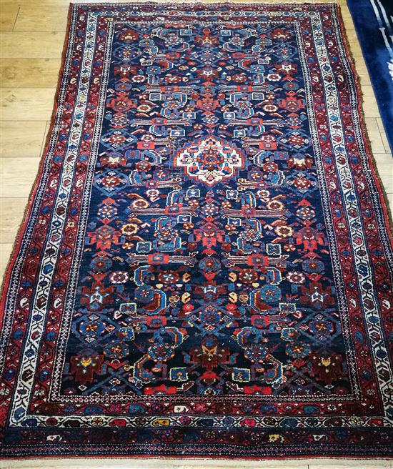 A Shivan red and blue rug with geometric motifs 205 x 135cm